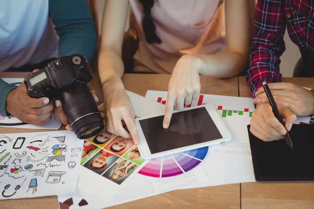 An image of three coworkers using data analytics and digital tools to showcase the surge in digital transformation within companies.