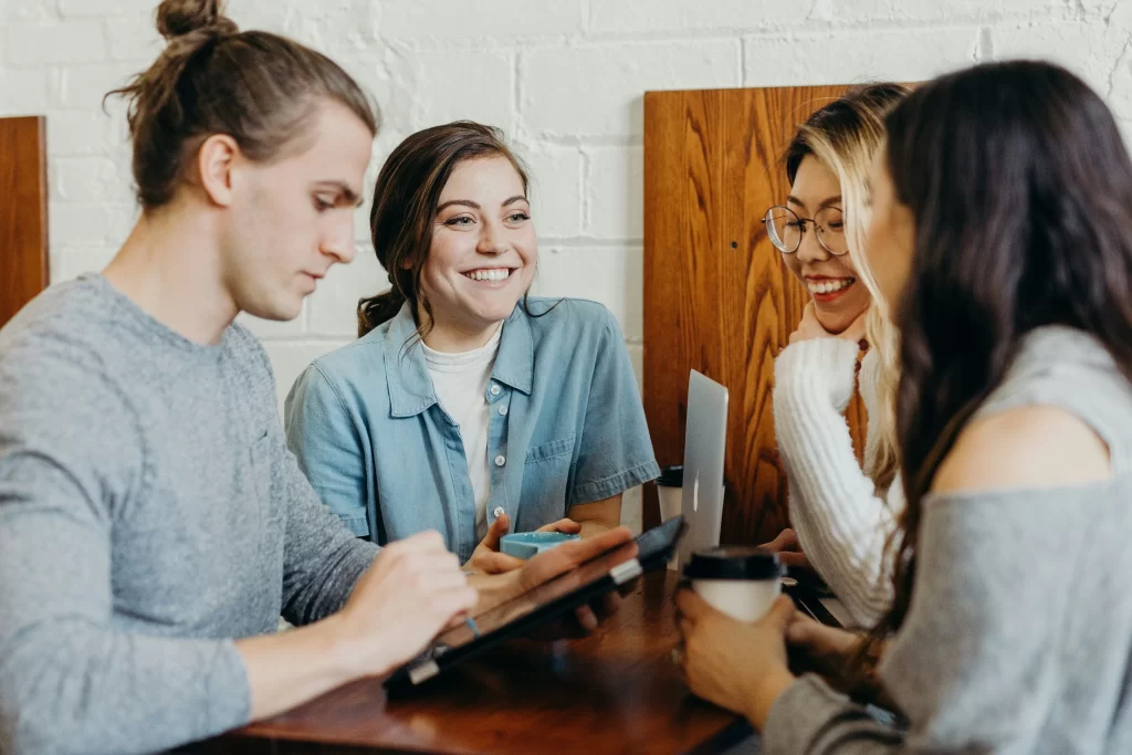 group of young professionals discussing PEO services during a team meeting