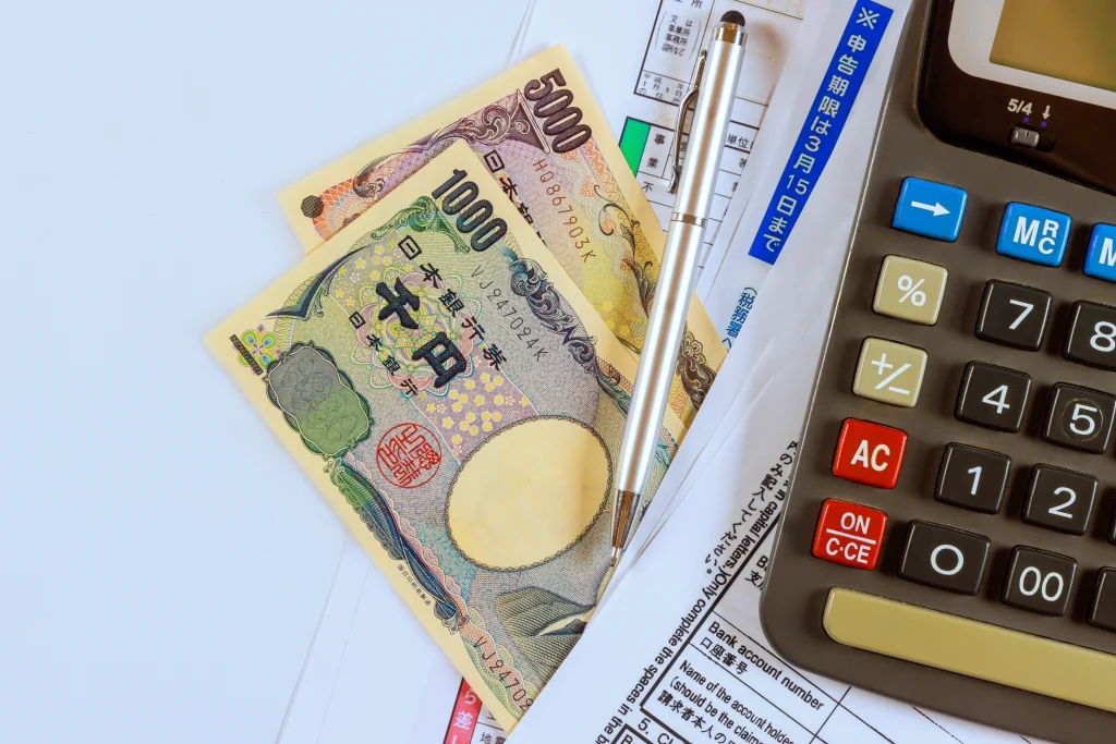 Japanese yen notes with calculator and financial forms illustrating ESG investment analysis
