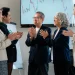 Asian business team applauding successful ESG investment results during a financial meeting.