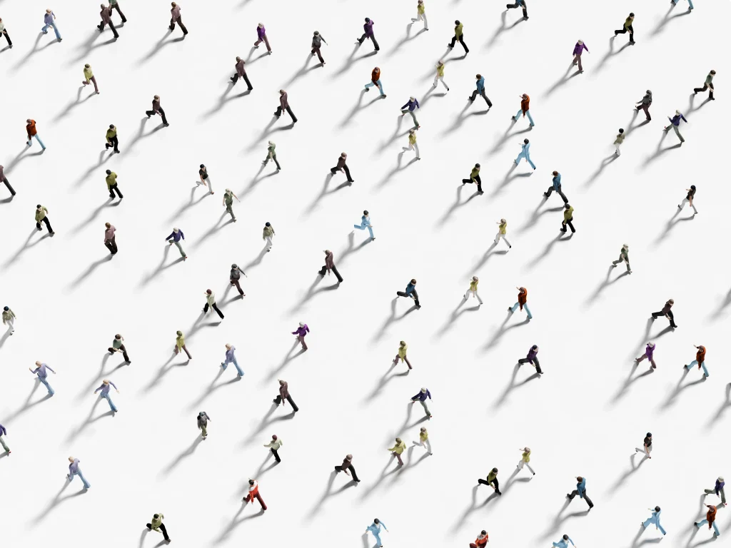 Top view of a diverse crowd walking in different directions, symbolizing the global nature and scale of crowdsourcing communities.